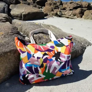 Tote bag Explosion Chromatique en toile de coton à motifs abstraits multicolores, avec anses en coton, fermeture par bouton magnétique et poche plaquée intérieure.
