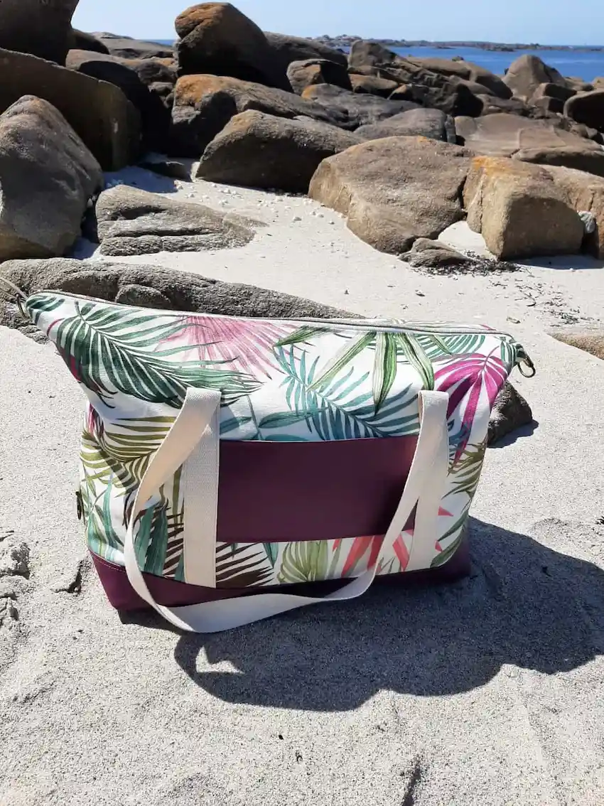 Sac Sierra vu de dos, en version ouverte avec les mousquetons défaits Le passe trolley intégré permet de le glisser sur la poignée de la valise.