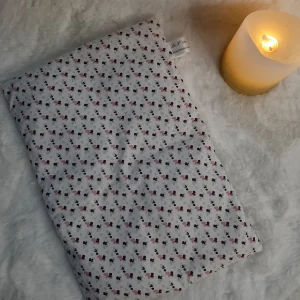 Bouillotte sèche aux grains de riz en coton motif léopard posée sur un plaid doux avec une bougie allumée – La P’tite Garçonnière